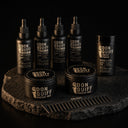 ENERGY MAX Set: 4 Don Quiff Energy Oil, 2 Energy Wax, Energy Powder und Kamm auf dunklem Stein